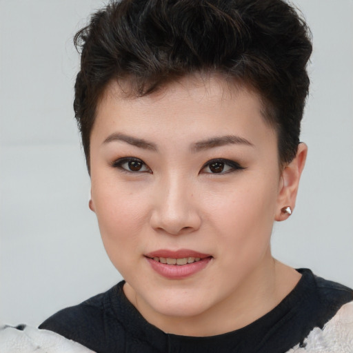 Joyful asian young-adult female with short  brown hair and brown eyes