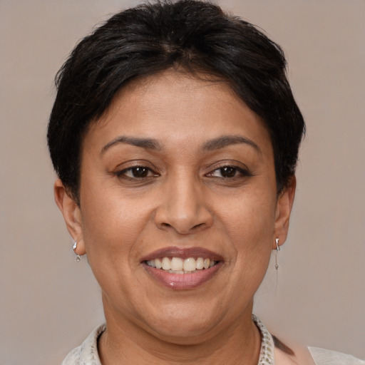 Joyful latino adult female with short  brown hair and brown eyes