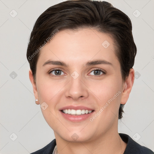 Joyful white young-adult female with short  brown hair and grey eyes