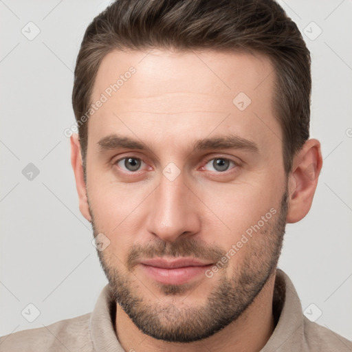 Joyful white young-adult male with short  brown hair and brown eyes