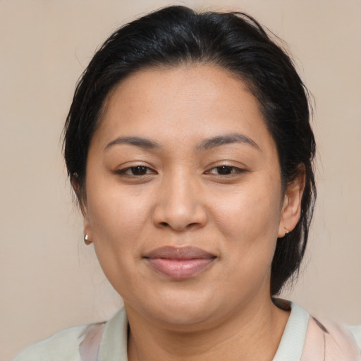 Joyful asian adult female with medium  brown hair and brown eyes