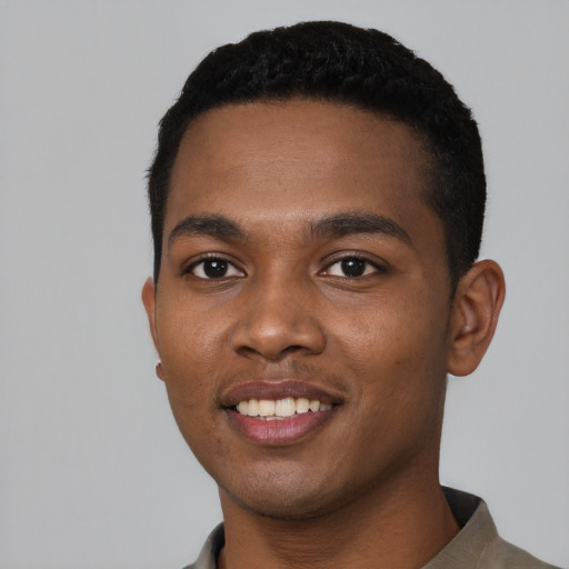 Joyful black young-adult male with short  black hair and brown eyes