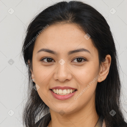 Joyful latino young-adult female with long  brown hair and brown eyes