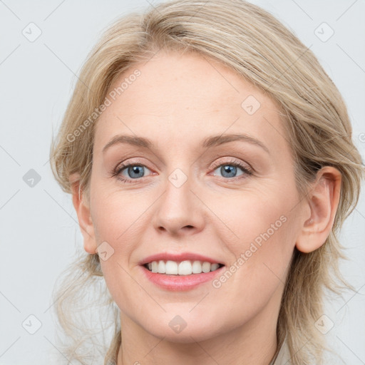 Joyful white young-adult female with medium  brown hair and blue eyes