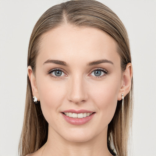 Joyful white young-adult female with long  brown hair and grey eyes