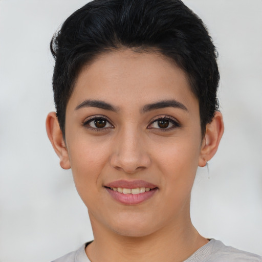 Joyful latino young-adult female with short  brown hair and brown eyes