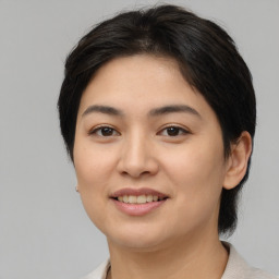 Joyful asian young-adult female with medium  brown hair and brown eyes