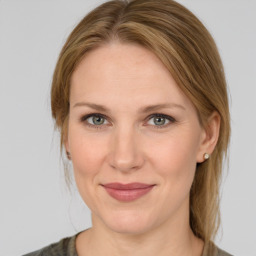 Joyful white adult female with medium  brown hair and grey eyes