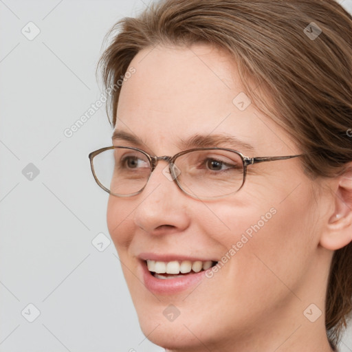 Joyful white adult female with medium  brown hair and blue eyes