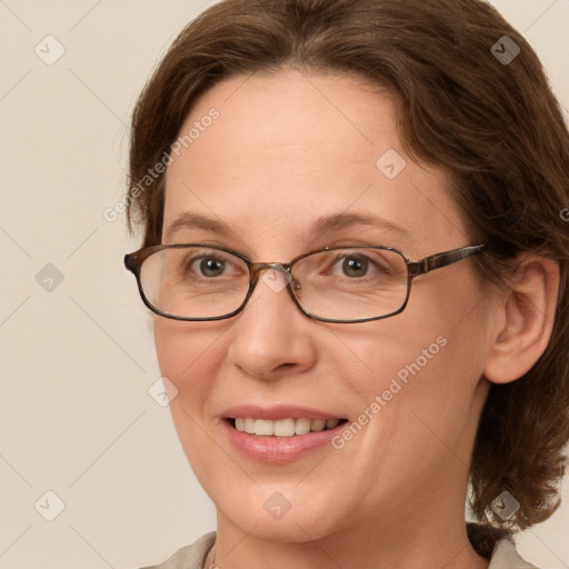 Joyful white adult female with medium  brown hair and grey eyes