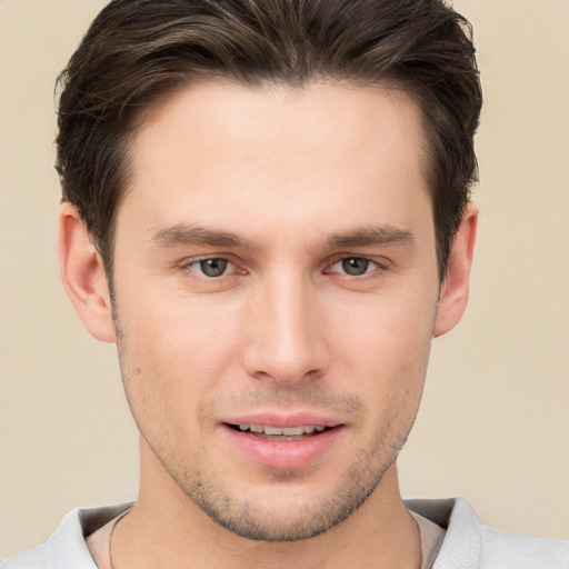 Joyful white young-adult male with short  brown hair and brown eyes