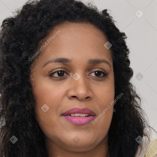 Joyful black young-adult female with long  brown hair and brown eyes