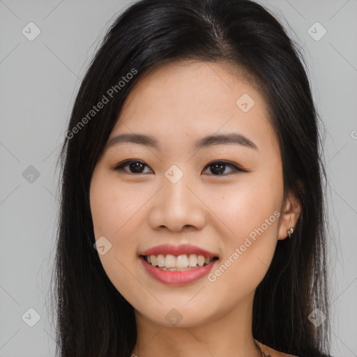 Joyful asian young-adult female with long  black hair and brown eyes