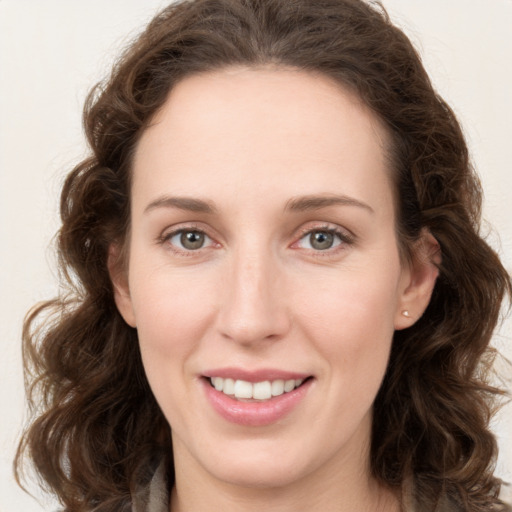 Joyful white young-adult female with long  brown hair and green eyes