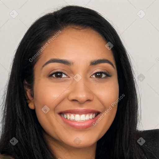 Joyful latino young-adult female with long  black hair and brown eyes