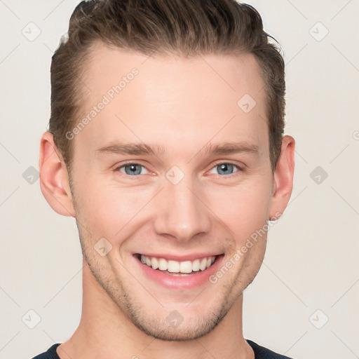 Joyful white young-adult male with short  brown hair and grey eyes