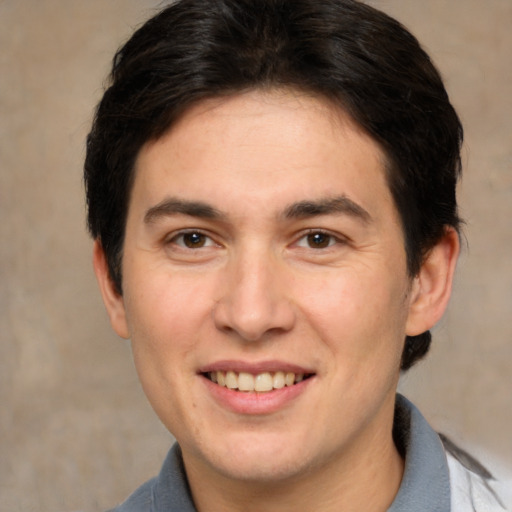 Joyful white adult male with short  brown hair and brown eyes