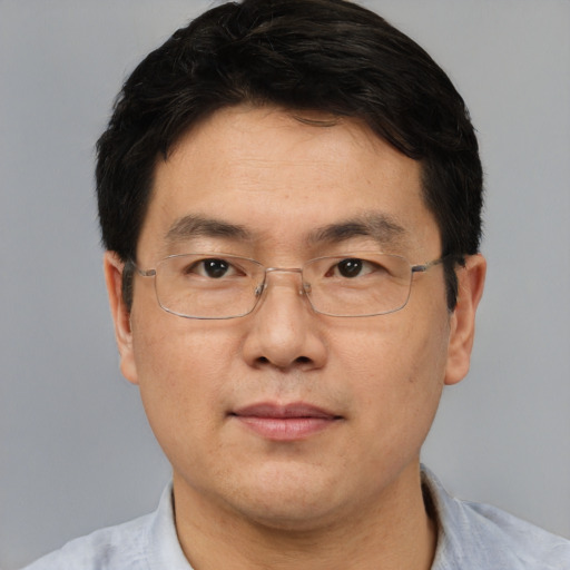 Neutral asian adult male with short  brown hair and brown eyes
