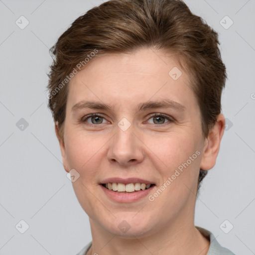 Joyful white young-adult female with short  brown hair and grey eyes