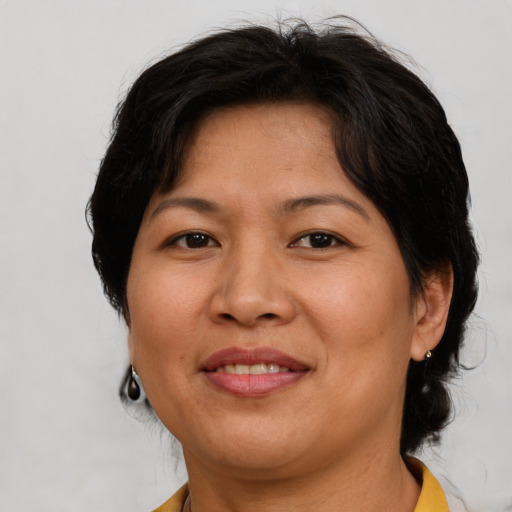 Joyful asian adult female with short  brown hair and brown eyes