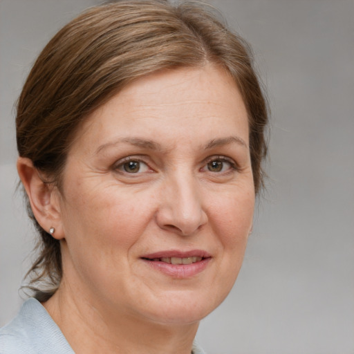 Joyful white adult female with medium  brown hair and grey eyes