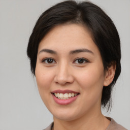 Joyful asian young-adult female with medium  brown hair and brown eyes