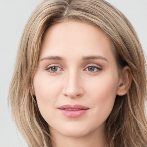 Joyful white young-adult female with long  brown hair and green eyes