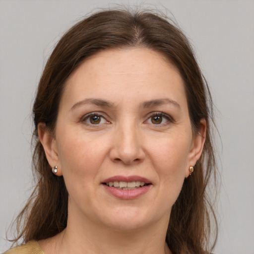 Joyful white adult female with medium  brown hair and brown eyes