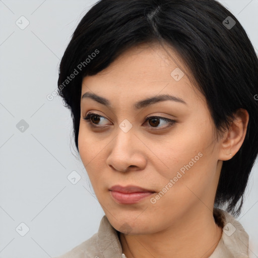 Joyful asian young-adult female with medium  black hair and brown eyes