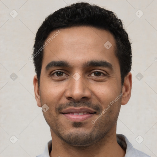 Joyful latino young-adult male with short  black hair and brown eyes