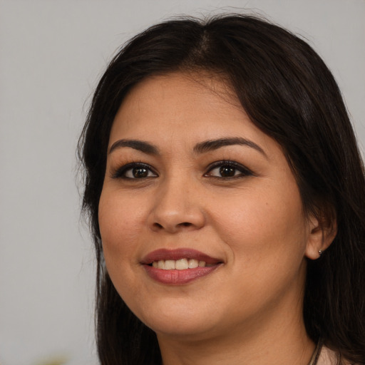 Joyful white young-adult female with long  brown hair and brown eyes