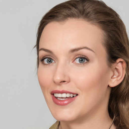 Joyful white young-adult female with long  brown hair and grey eyes