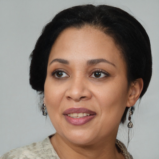 Joyful black adult female with medium  black hair and brown eyes