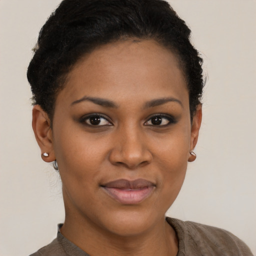 Joyful black young-adult female with short  brown hair and brown eyes