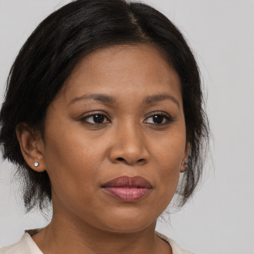 Joyful black young-adult female with medium  brown hair and brown eyes