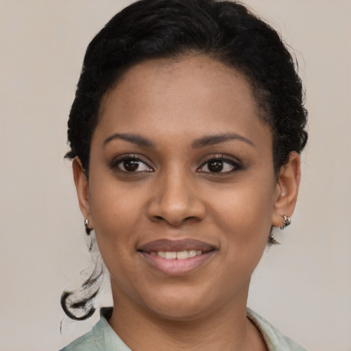 Joyful latino young-adult female with short  black hair and brown eyes