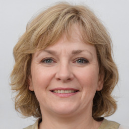 Joyful white adult female with medium  brown hair and grey eyes