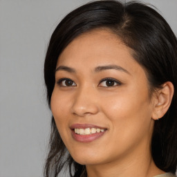 Joyful asian young-adult female with long  brown hair and brown eyes