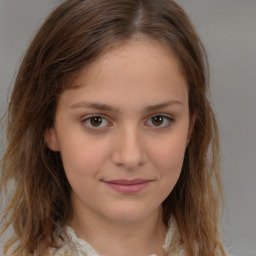 Joyful white child female with medium  brown hair and brown eyes