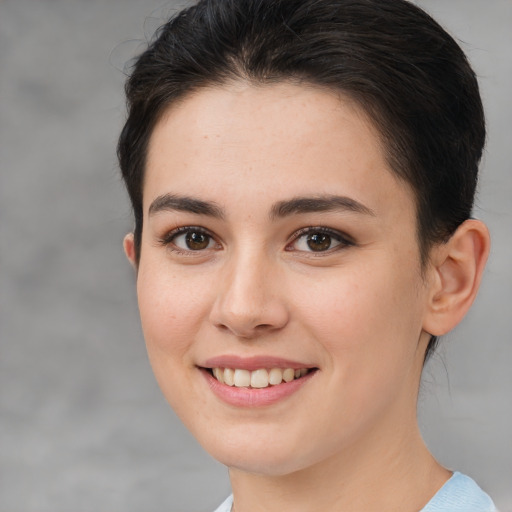 Joyful white young-adult female with medium  brown hair and brown eyes