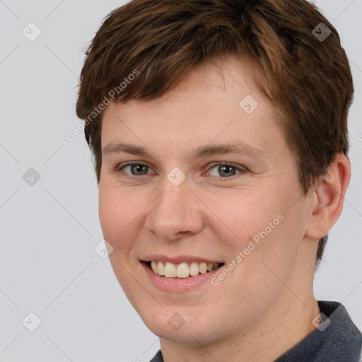 Joyful white young-adult female with short  brown hair and grey eyes