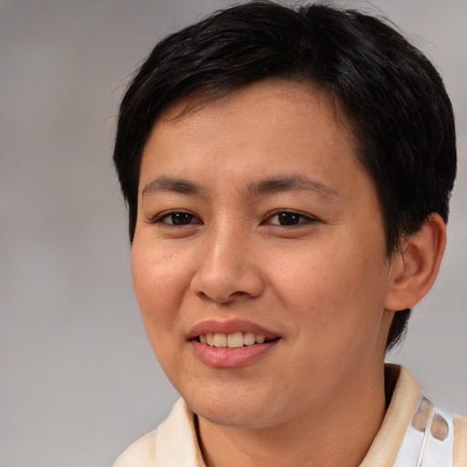 Joyful asian young-adult female with short  brown hair and brown eyes