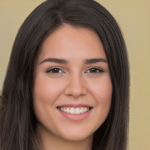 Joyful white young-adult female with long  brown hair and brown eyes