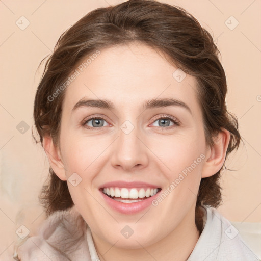 Joyful white young-adult female with medium  brown hair and blue eyes