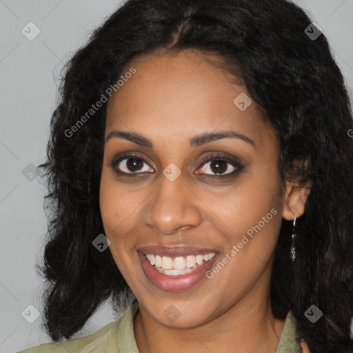 Joyful black young-adult female with long  brown hair and brown eyes