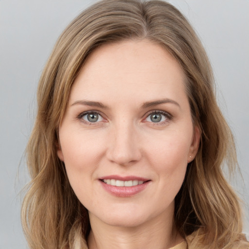 Joyful white young-adult female with medium  brown hair and green eyes