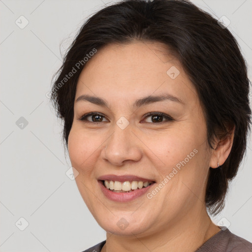 Joyful white adult female with medium  brown hair and brown eyes