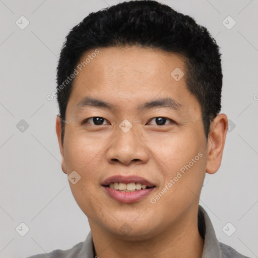 Joyful asian young-adult male with short  black hair and brown eyes