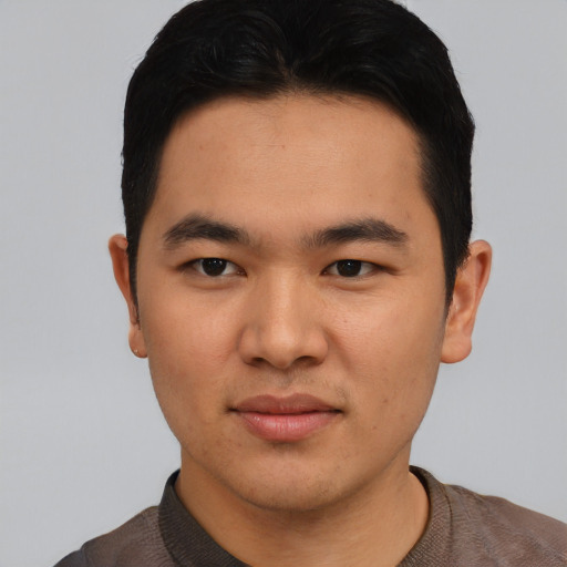 Joyful asian young-adult male with short  black hair and brown eyes