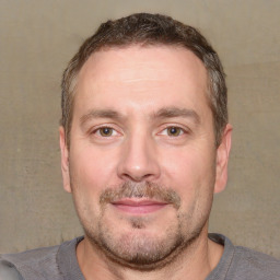 Joyful white adult male with short  brown hair and brown eyes